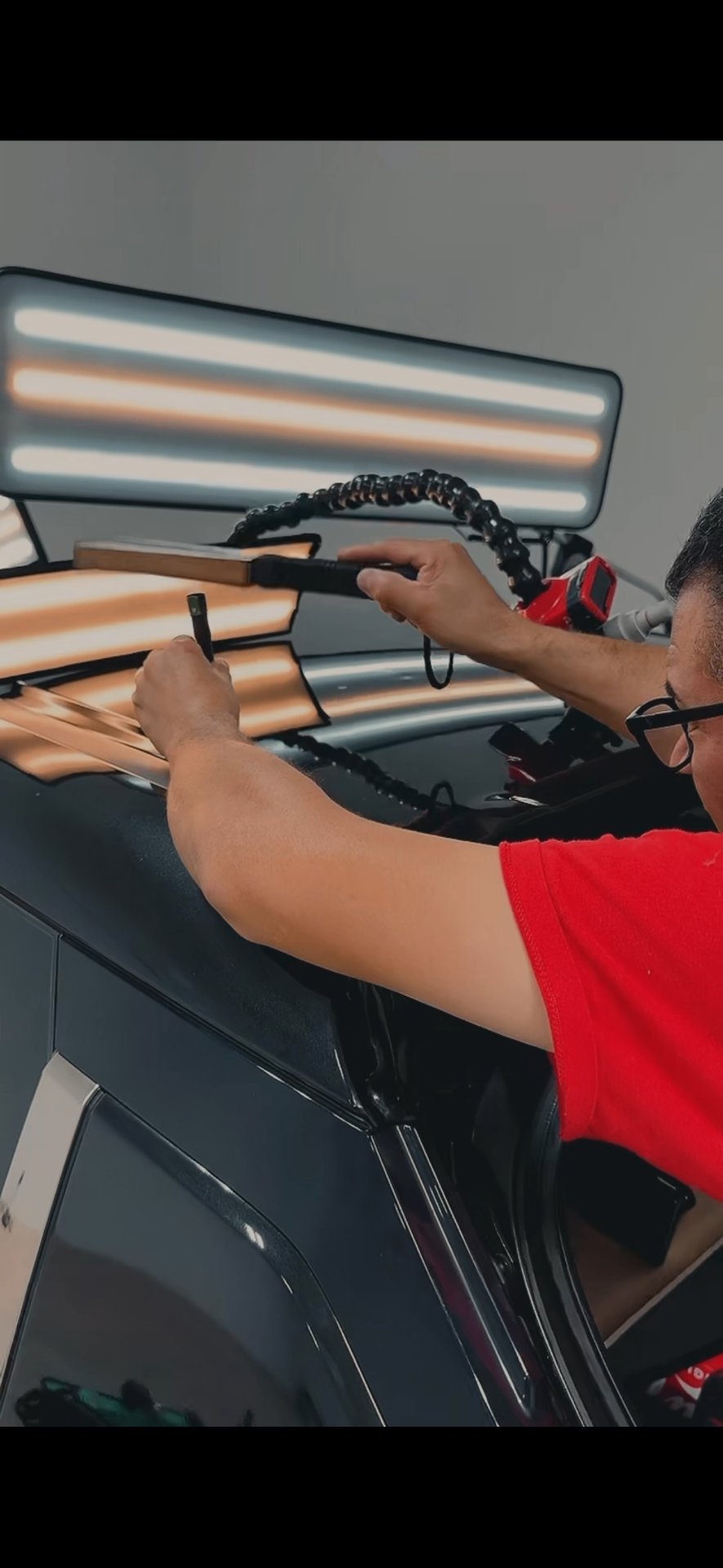 Technician performing paintless dent repair